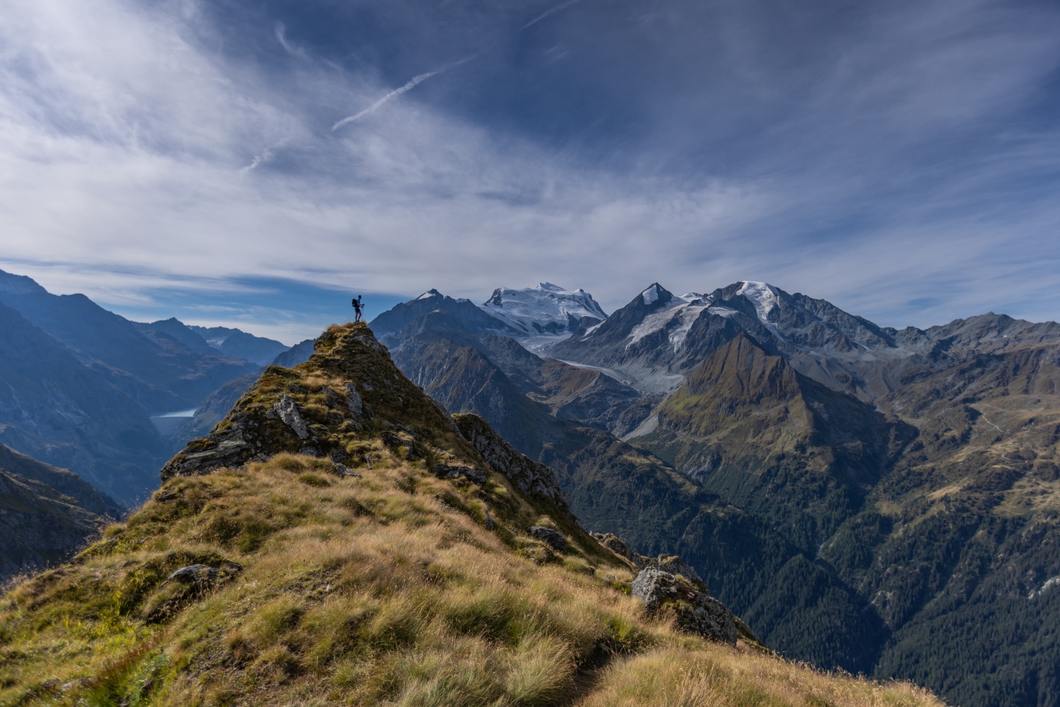 Man stood on mountain peak - Swiss alpine resort Verbier