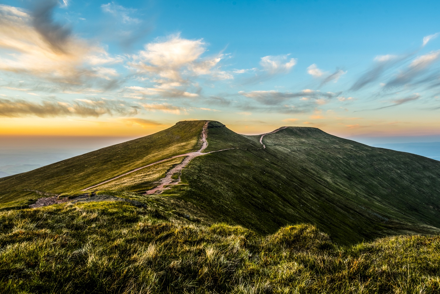 Footpaths along hills with cloudy blue sunset sky background_Climbing Pen y Fan, Wales