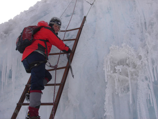Susie climbs a ladder over a crevasse, ascending Cotopaxi, Ecuador cotopaxi ladder over crevasse Ecuador